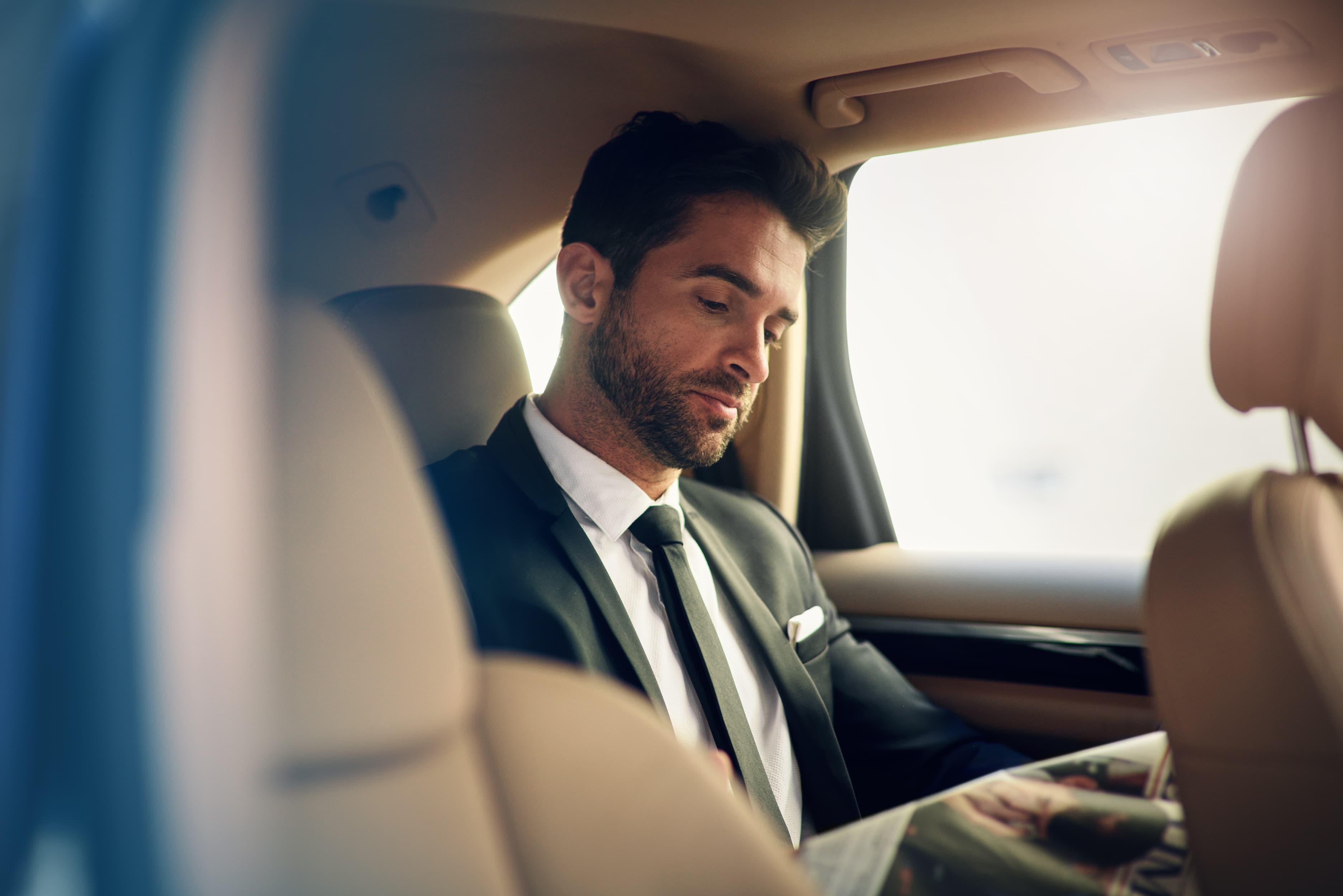 Professional chauffeur with luxury vehicle